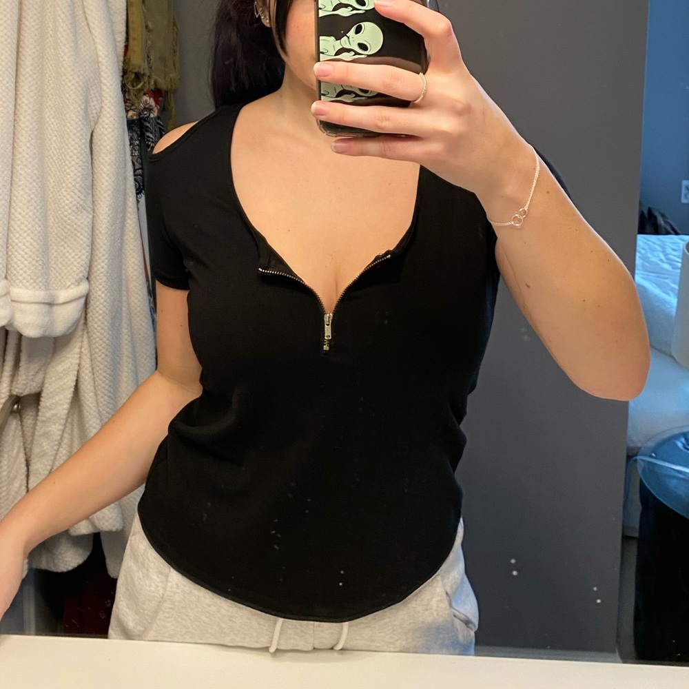 Black short sleeve top with gold zipper detail